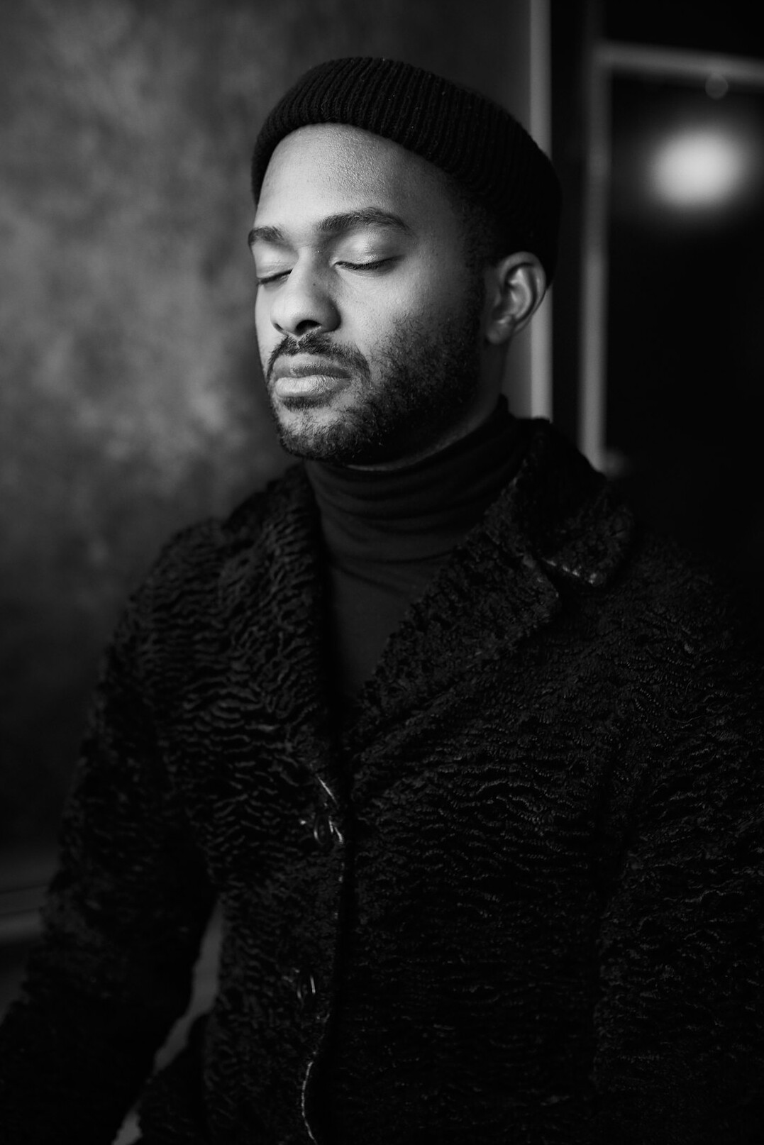 Studio portrait of a smiling Black man with short beard