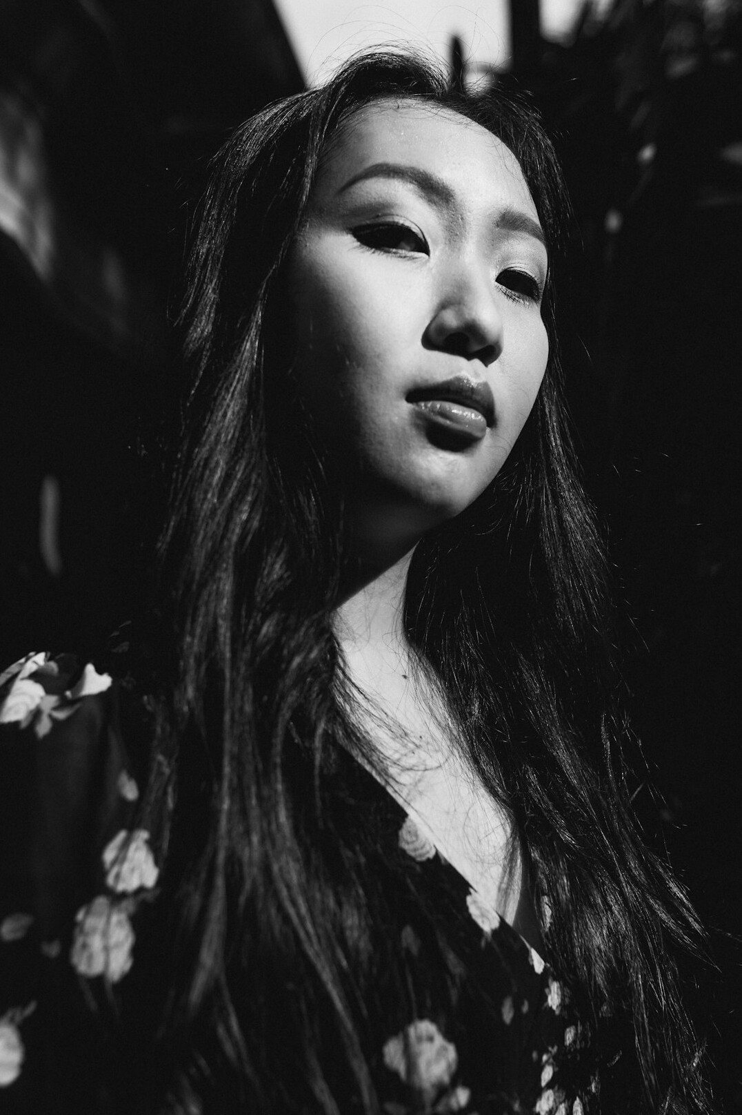 Studio portrait of a smiling Asian woman with long dark hair