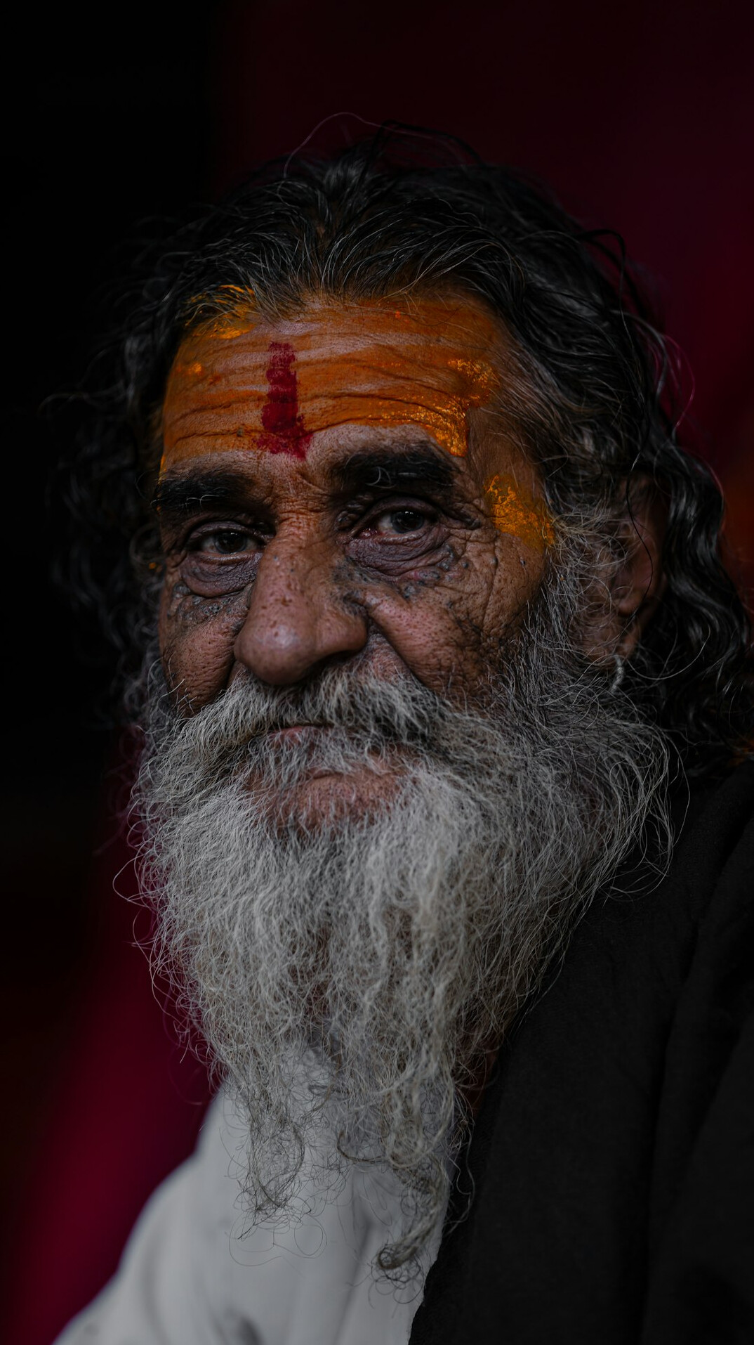 Studio portrait of a smiling Indian man with a beard