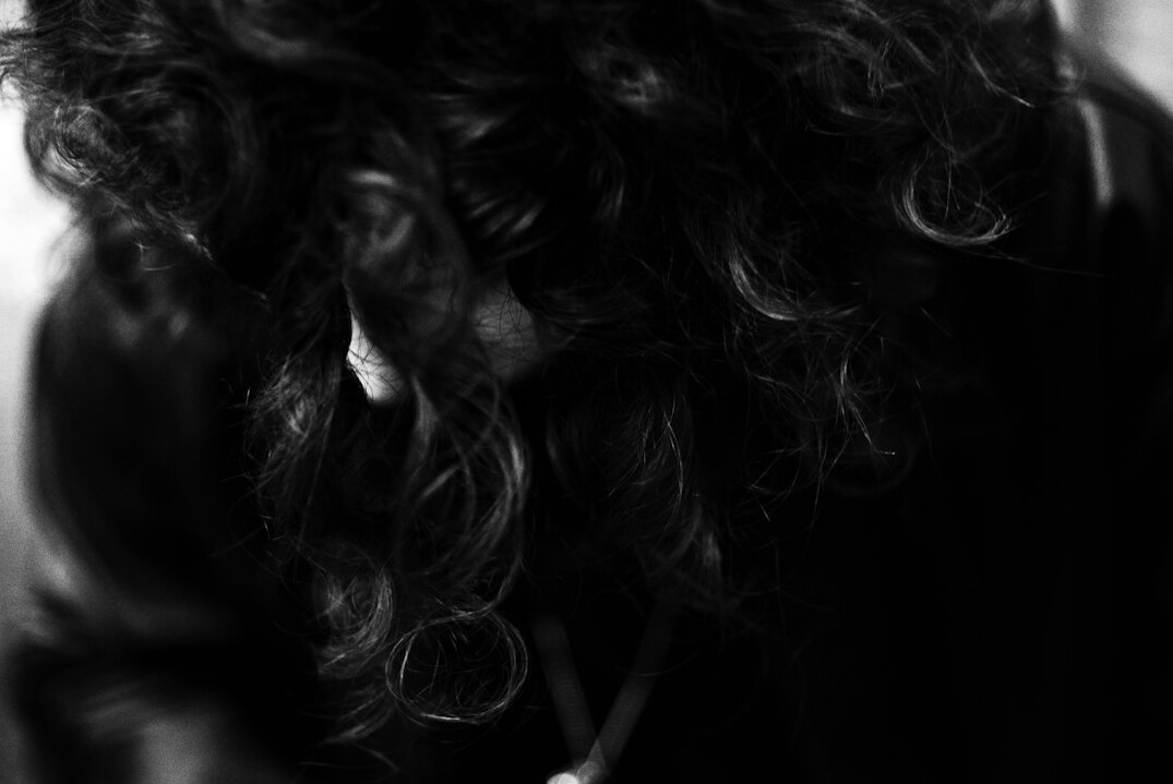 Studio portrait of a smiling Caucasian woman with curly hair