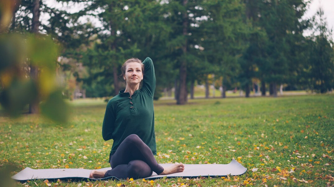 woman doing yoga in park