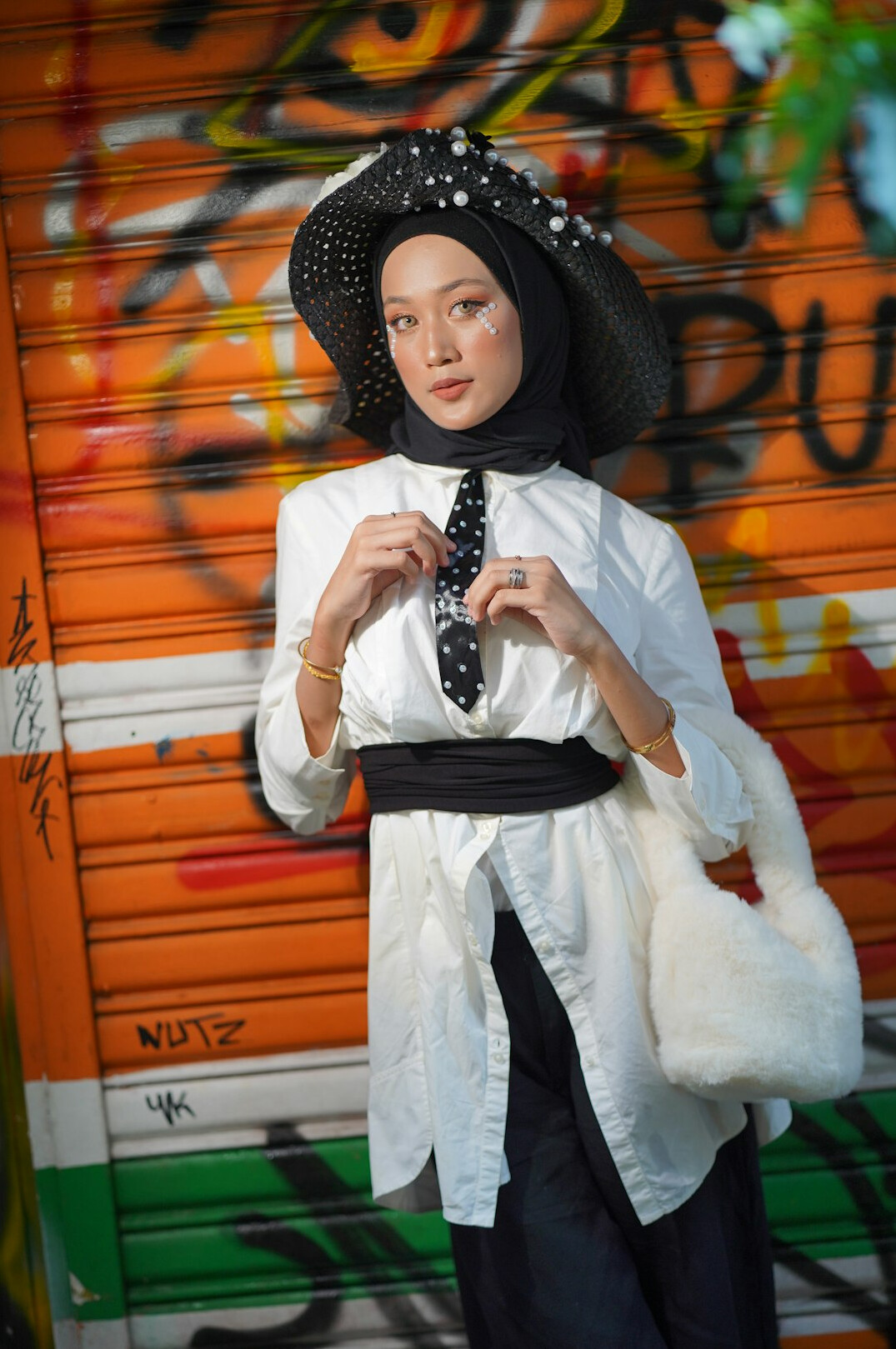 Studio portrait of a smiling Malay woman with hijab