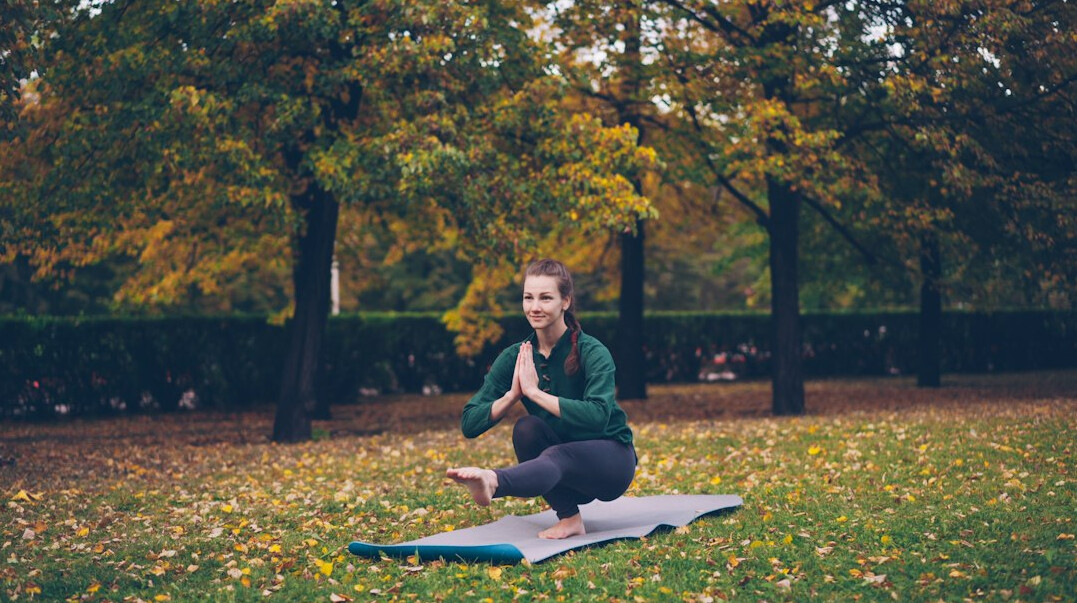 woman doing yoga in park